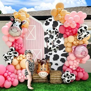 Cow print birthday party balloon arch kit with number 2 foil balloon and farm animal decor.