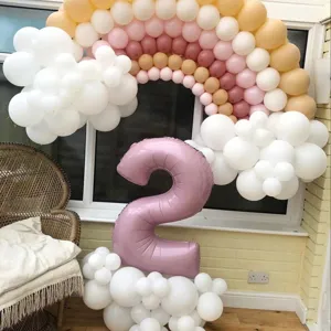 Pastel rainbow balloon arch kit with pink number 2 foil balloon for birthday party decor.