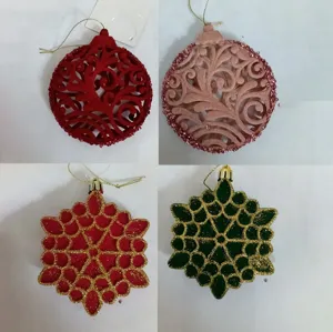Close-up detail view of assorted Christmas tree hanging ornaments, glitter and flocking finish.