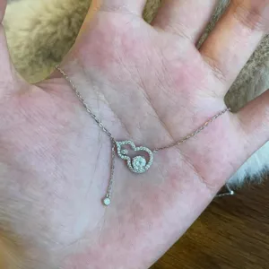 Detail view of the elegant gourd zircon pendant necklace, shining crystal stones, stainless steel.