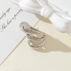 Detailed close-up of the minimalist silver geometric spiral ear cuff with fine metallic texture.