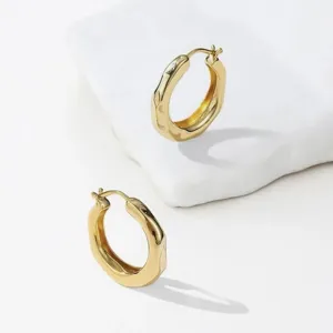 French minimalist gold hoop earrings, unique organic melted texture design, chic jewelry.