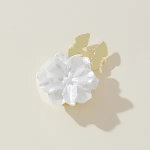 White floral shirt button cover stylish cuff clip accessory for elegant clothing decor.