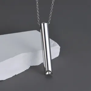 Detail of stainless steel anxiety breathing whistle pendant necklace for meditation mindfulness.