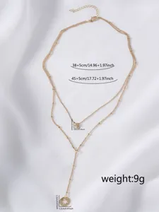 Dettaglio collana lariat multistrato dorata con ciondoli a stella e rotondi con misure.
