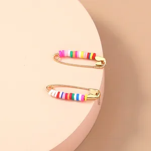 Detailed view of colorful polymer clay heishi beads gold safety pin stud earrings for women detail.