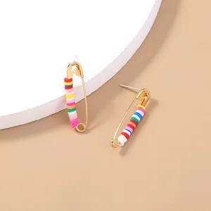 Detail shot of safety pin stud earrings with colorful clay beads, bohemian style metal jewelry.