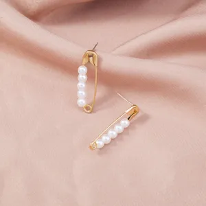 Elegant gold safety pin stud earrings adorned with delicate white faux pearls for women.