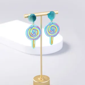 Blue pink lollipop acrylic drop earrings detailed view on gold display stand, chic cute jewelry.