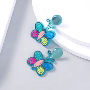 Colorful acrylic butterfly earrings detail showcase whimsical doodle design and bright colors.