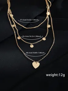Collana multistrato dorata da donna con dischi delicati e ciondolo a forma di cuore.