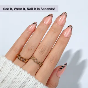 Almond press-on nails detail view showcasing French tiger stripe pattern and gold rings.