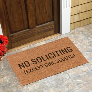 Detailed view of novelty coir door mat with funny text placed at front entrance porch.