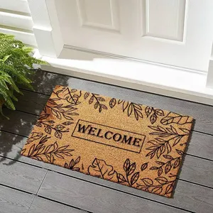 Détail d'un superbe paillasson élégant avec bordure de feuilles botaniques et texte d'accueil.