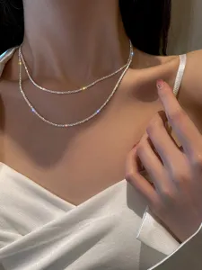 Detail shot of the elegant double-layer sparkling chain necklace, showcasing its brilliant texture.