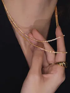 Minimalist starlight shimmering gold layered clavicle chain necklace for women, elegant jewelry.