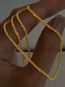 Close-up detail of the sparkling starry copper clavicle chain, delicate shine and texture.