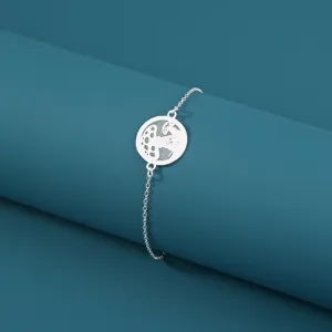 Nahaufnahme eines silbernen Metallarmbands mit einem runden hohlen Pilz-Anhänger.