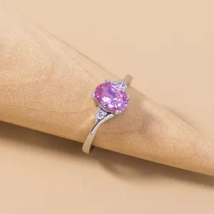 Dettaglio ravvicinato dell'anello minimalista in zircone rosa con pietre scintillanti.