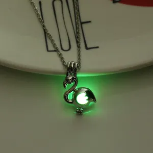 Luminous flamingo cage pendant necklace detail, glowing night effect jewelry accessory.