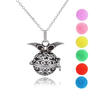 Detailed close-up of silver angel wings locket pendant with colorful diffuser balls.