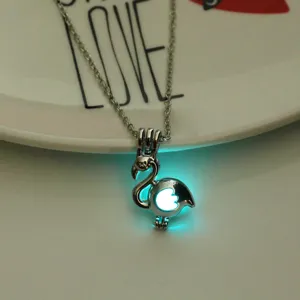 Glow in the dark flamingo pendant necklace detail view, luminous animal charm jewelry accessory.