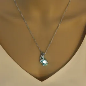 Detailed view of a luminous swan pendant necklace featuring a glowing bead and fine chain for women.