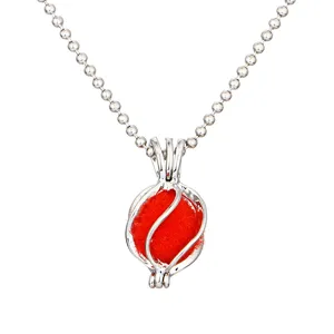 Hollow cage pendant necklace featuring a red ball and silver bead chain, retro style.