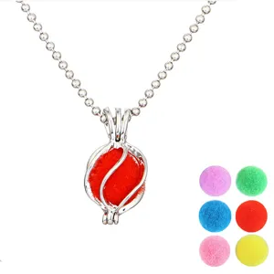 Close up of silver bead chain necklace with cage locket pendant and colorful fuzzy pom pom balls.