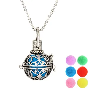 Detailed view of vintage silver hollow aromatherapy ball pendant necklace with colorful pom-poms