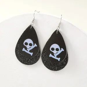 Nahaufnahme Detail von Halloween doppelschichtigen Leder-Ohrringen mit Totenkopf.