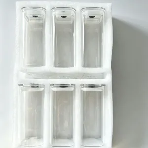 6-piece transparent rectangular glass storage jars set with lids in protective foam.