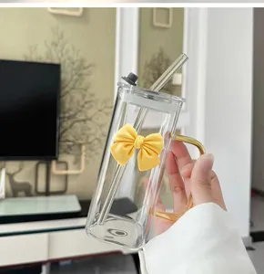 Transparent square glass cup with bow handle and straw for cool coffee drinks detail