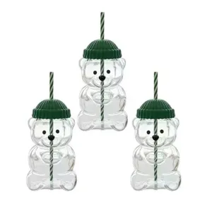 Detail shot of cute bear glass cup with green knit hat lid and striped straw, clear.