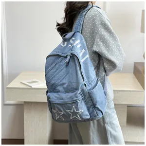 Detailed view of women casual denim canvas backpack, large capacity school bag with star patches.