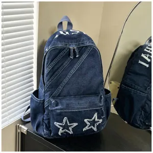 Washed denim backpack for women, casual school bag with star patches for daily use.