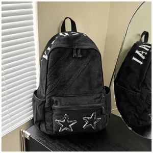 Black washed canvas backpack with gothic letters and star patches, casual student bookbag.