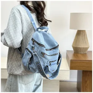 Retro denim backpack for women, casual multi-pocket design with metal studs and zippers.