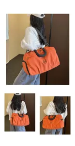 Orange large capacity travel duffel bag with shoulder strap and handles for gym use.