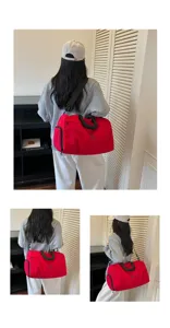 Detailed view of the red travel gym bag showing back and side carrying styles, large capacity.