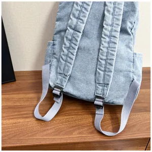 Casual denim backpack for women, large capacity washed canvas school bag for daily use.