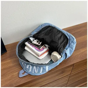 Washed denim backpack interior detail, large capacity canvas school bag with multi-compartments.