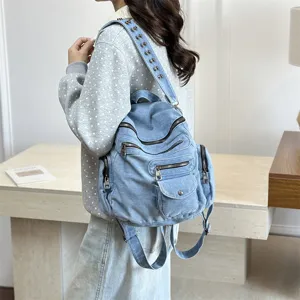Casual denim backpack for women, stylish multi-zipper school bag with retro rivet shoulder strap.