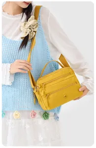 Casual solid yellow nylon women's crossbody shoulder bag with multi-zipper pockets