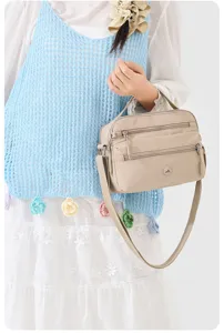 Close-up detail of lightweight nylon crossbody bag showcasing multi-pocket design and hardware.