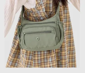 Detailed view of casual nylon cross-body shoulder bag with multi-zipper pockets and capacity.