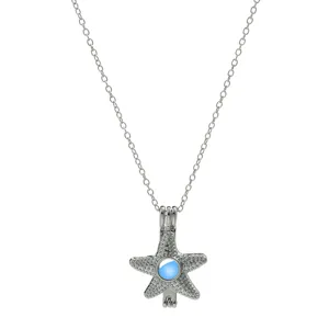 Close-up of a silver-toned starfish cage pendant necklace featuring a glowing blue bead inside.