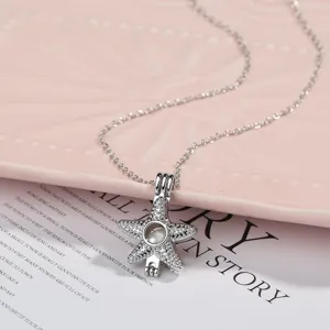 Detailed close-up of a sparkling rhinestone starfish cage pendant necklace with fine chain.