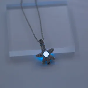 Luminous starfish pendant necklace detail shot, glowing night charm jewelry accessory.