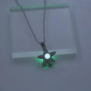 Detail view of glowing starfish pendant necklace with luminous effect and shiny rhinestones.
